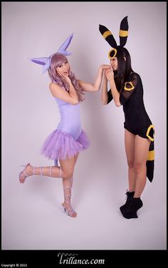 two women dressed up in costumes posing for the camera