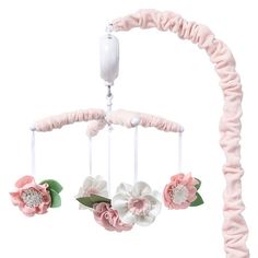 a pink and white baby mobile with flowers on it