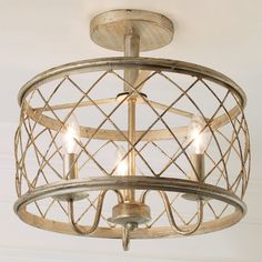 a chandelier hanging from the ceiling with three lights on it and an iron cage design