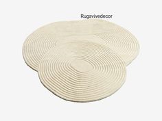 three white round rugs sitting on top of each other