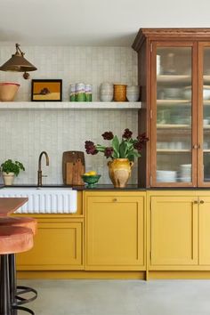 a kitchen with yellow cabinets and counter tops