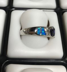 Fabulous brand new high quality silver ring with lab created blue inlay Fire Opals and 7mm Trillion cut Tanzanite, and White Topaz stones set on solid 925 sterling silver and stamped with 925. Our silver is genuine 925 sterling silver and Rhodium plated for better quality and prolonged shine. You will receive the item in a gift box Thanks for looking and check out more items in my Etsy shop for more great items and deals! https://www.etsy.com/shop/925usa Payment: We accept all major credit cards Gift Sapphire Ring Channel Set In Sterling Silver, Sterling Silver Opal Ring With Accent Stones, Silver Opal Ring With Accent Stones, Round Cut, Silver Multi-stone Opal Ring For Promise, Sterling Silver Channel Set Sapphire Promise Ring, Blue Trillion Cut Sterling Silver Ring, Silver Trillion Cut Sapphire Ring With Accent Stones, Blue Sterling Silver Rings With Channel Set, Sterling Silver Sapphire Jewelry With Channel Set