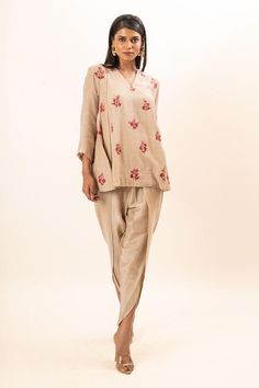 Beige tunic with scattered floral embroidery. Paired with a dhoti pant.
Components: 2
Pattern: Embroidery
Type Of Work: Floral
Neckline: V Neck
Sleeve Type: Three Quarter Sleeves
Fabric: Tunic: Chanderi, Dhoti Pant: Bamber silk, Lining: Mul cotton
Color: Beige
Other Details: 
Attached inner lining
Closure: Elastic
Occasion: Work,Resort - Aza Fashions Floral Embroidered Traditional Drape Sets For Navratri, Traditional Drape Sets With Floral Embroidery For Navratri, Navratri Sets With Floral Embroidery And Traditional Drape, Traditional Sets With Resham Embroidery Tunic, Linen Sets With Chikankari Embroidery In Straight Kurta Style, Anarkali Tunic Set With Floral Embroidery, Anarkali Set With Floral Embroidery Tunic, Traditional Festive Tunic With Traditional Drape, Traditional Drape Festive Tunic