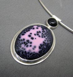 Pink and black abstract enamelled necklace in by Gracebourne Unique Black Oval Pendant Necklace, Silver Pendant With Black Enamel, Black Round Pendant Necklace, Black Hallmarked Round Pendant Necklace, Silver Necklace With Black Enamel In Distinctive Style, Modern Sterling Silver Jewelry With Black Enamel, Formal Pink Cabochon Necklace, Black Enamel Pendant Jewelry, Unique Black Enamel Pendant Necklace