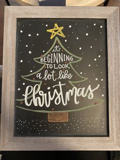 a framed christmas card saying it's beginning to look a lot like christmas tree