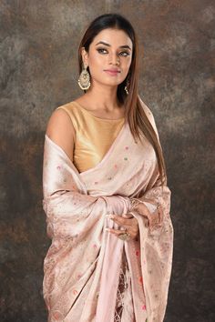 Look royal at weddings and festive occasions in this alluring powder pink Benarasi sari. The saree is crafted with heavy silver minakari zari jaal. It comes with a matching blouse piece. Disclaimer: The shown stitched blouse on the model is for display purpose only. The saree comes with a matching blouse piece and finished with fall and piko. Partywear Sarees, Bollywood Sarees, Tussar Silk Sarees, Fashion Journals, Tussar Silk Saree, Indian Saree, Traditional Fabric, Bollywood Saree, Powder Pink