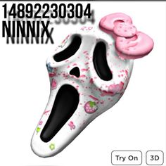 a white and black mask with pink sprinkles on it