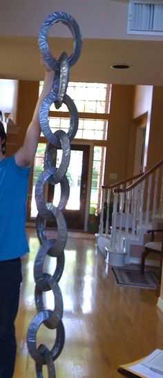 a man holding up a giant metal object