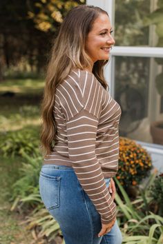 Fit & Details: True to size with great stretch. Lightweight knit material with ribbed hems V-neckline Center seam detail Drop shoulder sleeves Measurements: X-Small: Bust 36" Length 22" Small: Bust 38“ Length 22.5“ Medium: Bust 40“ Length 23“ Large: Bust 42“ Length 23.5“ X-Large: Bust 44" Length 24" Fabric & Material Care: Machine wash cold on delicate. Lay flat to dry. 55% Viscose, 45% Nylon. *Imported* Model Info: Britta is modeling a small. Leah is modeling a large. Leah R. is modeling a medium. Casual Brown Sweater With Ribbed Neckline, Casual Brown Knit V-neck Sweater, Casual Brown Top With Ribbed Neckline, Casual Knit Taupe Top, Casual Taupe Knit Tops, Casual Soft Knit Brown Tops, Brown V-neck Tops For Fall, Casual Ribbed Brown Knit Top, Casual Brown Soft Knit Top