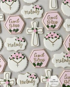 decorated cookies with pink and white icing are arranged on a gray background, which says god's biscuits