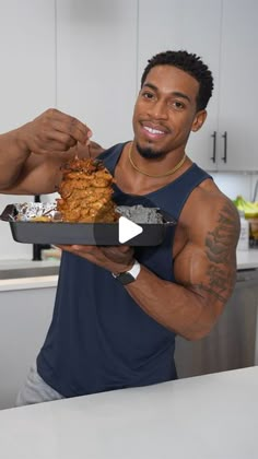 a man holding a tray full of food