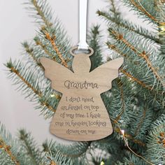 an angel ornament hanging from a christmas tree