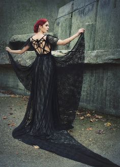 "Floor-length handmade dress with drapes, train and complex ropework design, showing a stylized bat from ropes on the back. Made from black lace with gray lining (can be made in other colour combinations as well). The dress will be made to measure. ROHMY Gold Label \"Eden\" Collection (Wedding-/ Evening) Gown \"Bat\" As I will produce the dress after you've placed your order, I can make it also in another colour or material if you wish, just let me know and we can talk about the possibilities of making that dress individual and especially for you. If you decide for another colour or material and alterations, production time may vary depending on if the material in your favourite colour is in stock or has to be ordered first. Please contact me before you place your order and I will inform y Black Wedding Dress With Lace-up Back, Black Floor-length Gown For Costume Party, Black Wedding Gown With Lace Back, Black Floor-length Gown With Back Opening, Black Lace Back Floor-length Evening Dress, Gothic Floor-length Costume Gown, Black Floor-length Dress With Lace Back, Gothic Black Floor-length Gown, Black Gothic Floor-length Gown