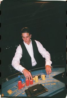 a man sitting at a casino table with his hands on the roule