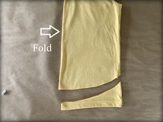 a piece of yellow cloth with an arrow pointing to it