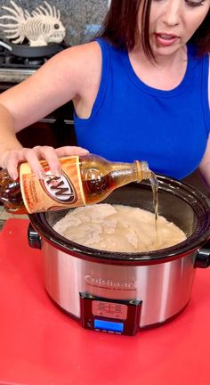 a woman pouring sauce into an instant pot