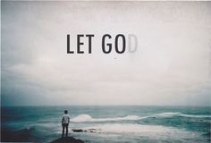 a man standing on top of a rock near the ocean with words written in it