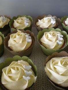 several cupcakes with white frosting on top