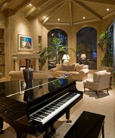 a living room filled with furniture and a piano