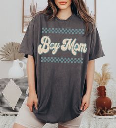 "Comfort Colors Boy Mom T-Shirt Colors are (Ivory ) and ( Pepper) -UNISEX Comfort Colors C1717 T-SHIRTS -100% ring-spun cotton - Preshrunk, soft-washed, garment-dyed fabric  -Set-in sleeves  -Double-needle stitched sleeves and bottom hem  -Twill taped shoulder-to-shoulder  -1\" ribbed collar with double-needle topstitched neckline Please order 1 or 2 sizes up for an oversized look. These ultra soft pigment dyed shirts are one of our best sellers! Please use the provided sizing chart when selecting a size, when in doubt- SIZE UP! I DO NOT ACCEPT EXCHANGES OR RETURNS: all items are made to order. PROCESSING AND SHIPPING 3-5 business days for processing Allow 1-7 business days for shipping CARE INSTRUCTIONS Wash inside out with similar colors Tumble dry low or hang to dry Try not to iron Mach Boy Mom Shirt, Mom Of Boys Shirt, T Shirt Boy, Boy Mama, Vintage Boy, Fabric Set, Vintage Boys, Mom Life Shirt, Dye Shirt