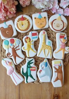 decorated cookies in the shape of animals on a basket