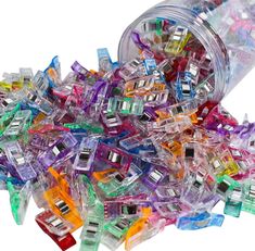 a jar filled with assorted colored plastic clips