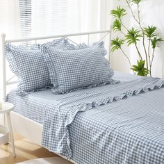 a bed with blue and white gingham sheets