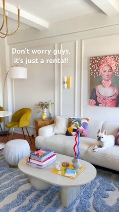 a living room filled with furniture and a painting on the wall