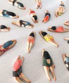 there are many small figurines laying on the floor together, all in different shapes and sizes