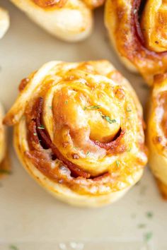 several small pastries with meat and cheese on them