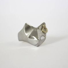 a silver ring with a cat's head cut out on the front and side