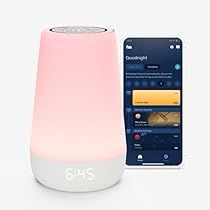 a pink and white speaker next to an iphone