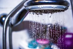 a shower head with water running down it