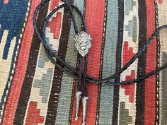 "This awesome bolo tie has a solid pewter buffalo head. The cord is genuine leather. Our bolos pair nicely with many of our belt buckles! They make wonderful gifts. The western bolo tie rope length is 100cm(39\") ; charm agate stone pendant size is 1 1/2'' x 2''" Adjustable Black Bolo Tie For Rodeo, Adjustable Black Bolo Ties For Rodeo, Black Adjustable Bolo Ties For Rodeo, Black Western Bolo Tie With Concho, Black Western Bolo Tie With Adjustable Length, Western Black Bolo Tie With Adjustable Length, Western Style Black Bolo Tie With Adjustable Length, Western Black Bolo Ties For Western-themed Events, Black Concho Jewelry For Western-themed Events