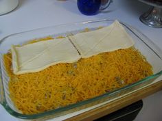 a casserole dish with cheese and other toppings on the side, ready to be eaten