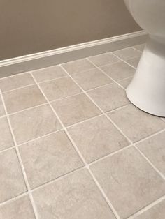 a white toilet sitting on top of a bathroom floor