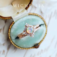 an opal and diamond ring sits in a box