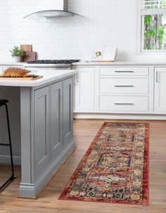 a kitchen with an area rug on the floor