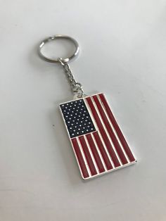 an american flag keychain is shown on a white surface