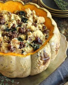 a stuffed pumpkin filled with stuffing sitting on top of a table