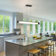 a large kitchen with stainless steel appliances and counter tops