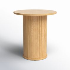 a round wooden table sitting on top of a white floor