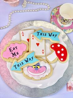 decorated cookies sitting on top of a white plate