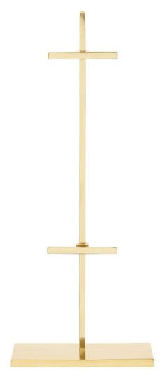 a gold cross on a wooden stand against a white background