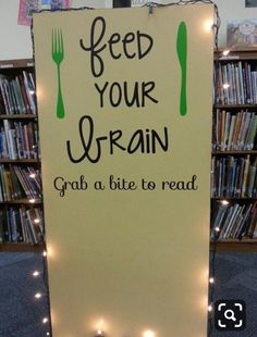 a sign that reads feed your brain grab a bite to read with forks and spoons