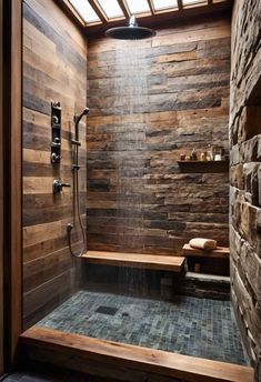 a bathroom with stone walls and wooden flooring, along with a walk in shower