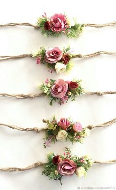 three different types of flowers are tied up together with twine on the wall behind them