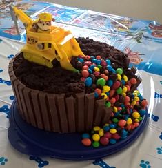 a cake with chocolate frosting and candy in the shape of a bulldozer