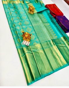 The saree is made of pure silk kanjeevaram/kanchipattu with 2 gram gold zari, Pallu, and blouse.  this grand saree is ideal for wedding parties ocations and festivals  Upon request: Tussels, fall and pico and blouse work (will be done with extra charges  Excellent quality with beautiful colours and combinations. Gold Traditional Wear Silk Mark Certified For Festivals, Gold Traditional Wear For Festivals With Silk Mark, Gold Silk Mark Certified Saree For Puja, Gold Silk Mark Certified Saree For Festivals, Gold Traditional Wear For Festive Season, Silk Mark Certified, Gold Traditional Wear With Silk Mark For Festivities, Festive Gold Traditional Wear With Silk Certification, Grand Saree, Kanchipattu Sarees