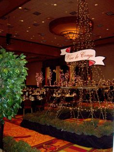 a large christmas tree in the middle of a room with lights and decorations on it